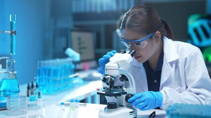 Scientist using microscope analyzing samples in laboratory