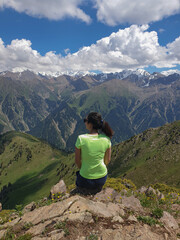 Woman in Green Shirt Enjoying Mountain View
