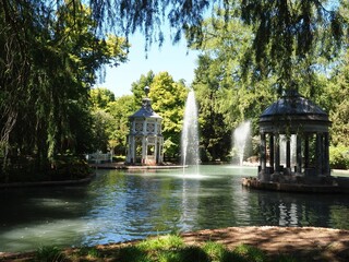 Serene garden scene with fountains and gazebos.