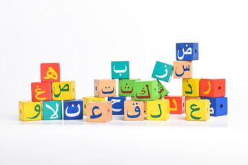 Wooden Arabic Alphabet Blocks isolated on white background. Arabic Alphabet Cubes. Preschool and education concept. Copy space