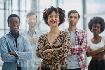 a team of young designers sticking notes on glass in a modern office