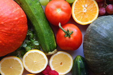 Various seasonal fruits and vegetables on white background. Summer and fall produce. Top view.