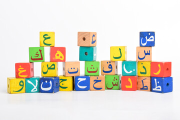 Wooden Arabic Alphabet Blocks isolated on white background. Arabic Alphabet Cubes. Preschool and education concept. Copy space