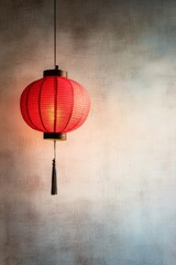 Obraz premium Red lantern hanging against a simple pastel background