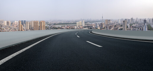 Scenic Overlook: Curved Urban Roadway with City Skyline View