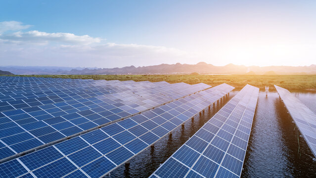 Breathtaking View of Solar Panels Reflecting in Water at Sunset