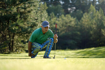 Successful golfer successfully places ball on green