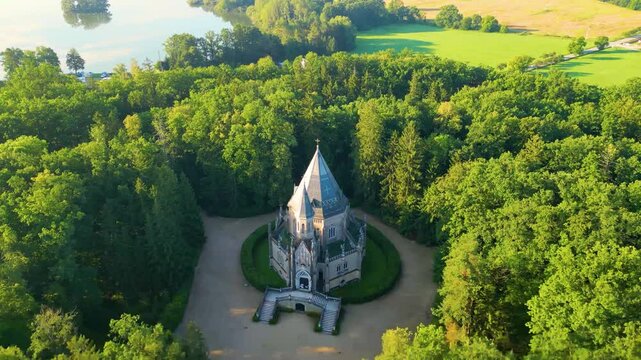 The video showcases the stunning Schwarzenberg tomb located in Domanin, near Trebon, Czechia, surrounded by lush greenery and a serene landscape, highlighting its architectural beauty.