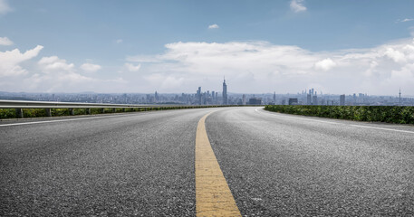 Urban Road Leading Towards a Majestic City Skyline