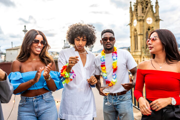 Friends dancing dressed with Hawaiian necklace in a rooftop party