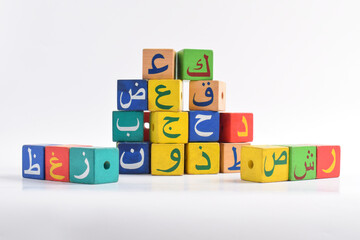 Wooden Arabic Alphabet Blocks isolated on white background. Arabic Alphabet Cubes. Preschool and education concept. Copy space