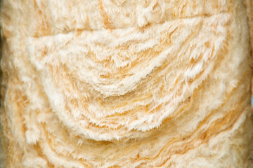 Close-up of layered, textured rockwool insulation roll on building site