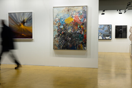 Parma, Italy - march 3 2024: People Walking and Admiring Paintings in a Modern Art Gallery