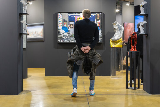 Parma, Italy - march 3 2024: People Walking and Admiring Paintings in a Modern Art Gallery