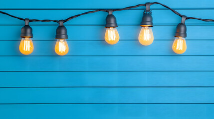 Light bulb garland hanging on rustic wooden wall 