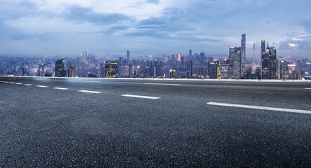 Fototapeta premium Urban Cityscape View with Empty Road Leading to Skyline