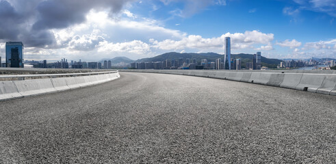 Scenic Panoramic View of a Curved Urban Road with City Skyline
