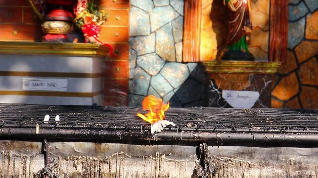 wax candles lit and burning at church alter