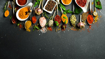 Variety of spices and herbs on kitchen table. Top view. Free space for text.