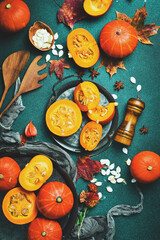 Autumn banner with pumpkins. Orange pumpkins on a stone table, holiday decoration. Pumpkin menu. Top view.