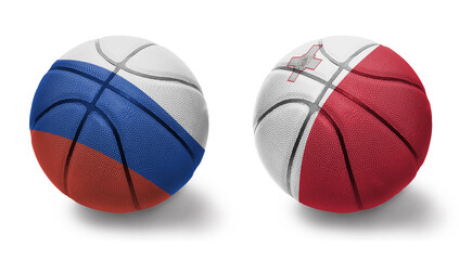 Obraz premium basketball balls with the national flags of malta and russia on the white background.