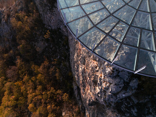 Aerial scenic view of modern and futuristic glass skywalk viewpoint, extending over mountain Ovcar and Kablar canyon in Serbia. Meanders of West Morava river. Ovcarsko-Kablarska gorge.