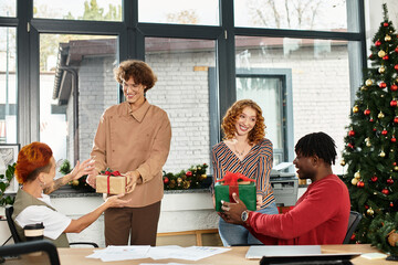 A lively celebration among coworkers as they exchange gifts during the Christmas season.