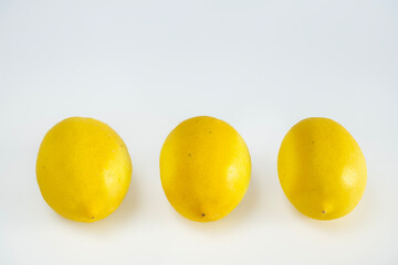 Beautiful whole bright lemons on a white background