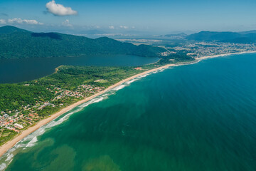 Obraz premium Coastline with mountains and sandy beach in Brazil. Aerial view