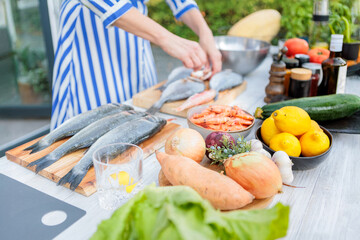Woman Preparing Fresh Ingredients Outdoors for Entertaining Guests