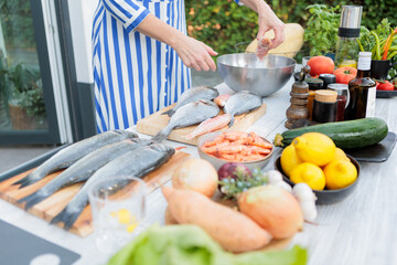 Woman Preparing Fresh Ingredients Outdoors for Entertaining Guests