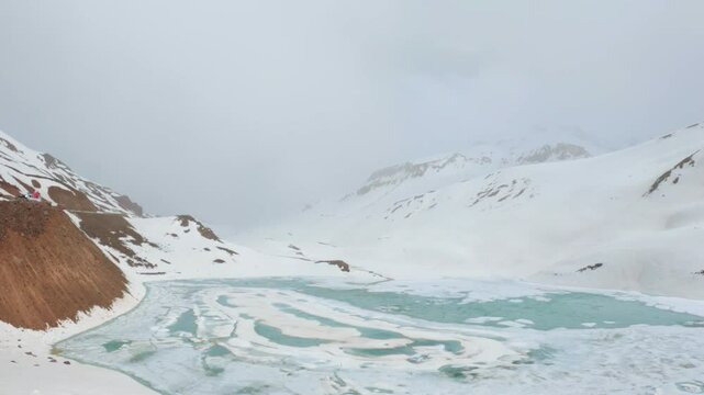 4K shot of frozen Suraj Tal lake as seen on the way towards Bara Lacha La Pass in Lahaul and Spiti district, Himachal Pradesh, India. Frozen lake due to the cold temperatures in winter season.
