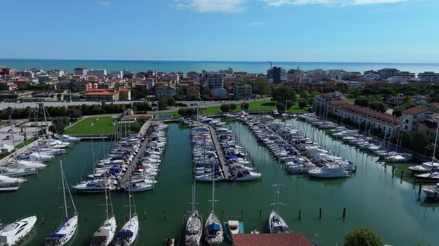 aerial view of luxury yachts and pleasure craft in the up-scale community harbor of Darsena dell'Orologio, Caorle, Italy
