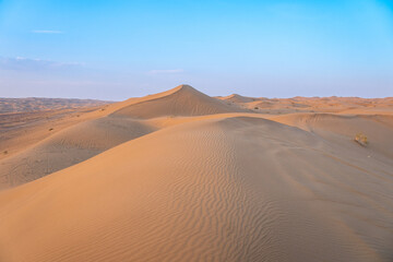 The vibrant sun is slowly setting over a vast desert landscape, Kashan, Iran