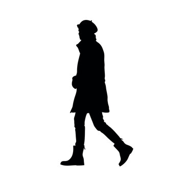 recommend clip art: a silhouette of a person walking in a stylish trench coat and boots