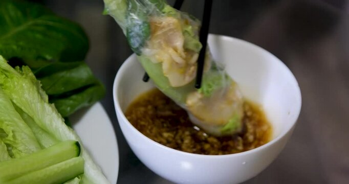 Spring roll with chicken or shrimps in rice paper with sweet and sour sauce close-up, cooking traditional korean chinese food. spring rolls making process step by step