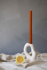 Handmade beeswax candle, interior design with authentic decor