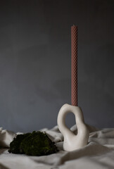 Handmade beeswax candle, interior design with authentic decor