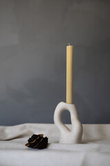 Handmade beeswax candle, interior design with authentic d&eacute;cor