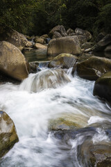 Slow shutter image of water flowing through the rocks creating a smooth silky effect in Taiwan