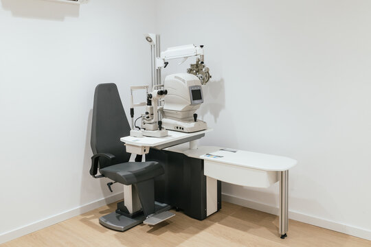 Modern optometry equipment standing in empty exam room