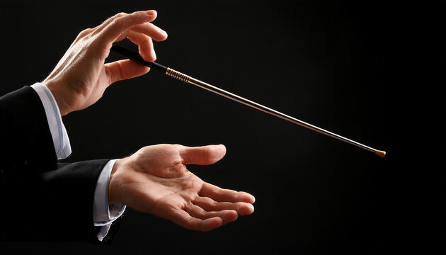 Close up de las manos de un director de orquesta con una batuta dirigiendo en fondo negro para conciertos, &oacute;pera, m&uacute;sica cl&aacute;sica eventos culturales carteles de &oacute;pera, festivales y campa&ntilde;as musicales