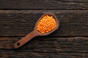 Lens culinaris - Organic red lentils on the spoon.