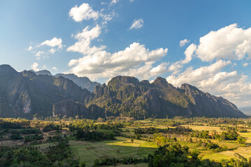 Fototapeta premium Countryside with farmland and karst mountains in the Vang Vieng. Vang Vieng, Vientiane Province, Laos