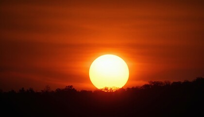 a sunset with silhouettes of distant trees