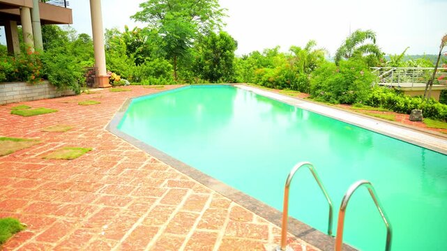 Attractive Swimming Pool Surround by Greenery