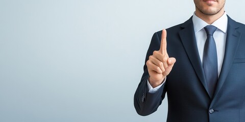 A businessman in a suit gestures with one finger to convey a message.