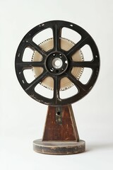 Obraz premium Vintage film reel on wooden stand.