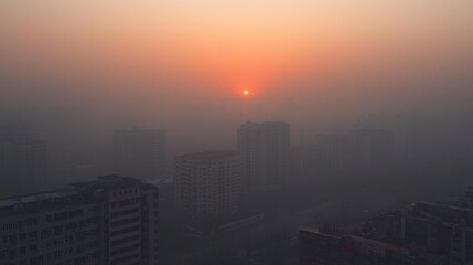 Fototapeta premium Sunset obscured by thick smog, showing how air pollution dims the natural beauty of the environment