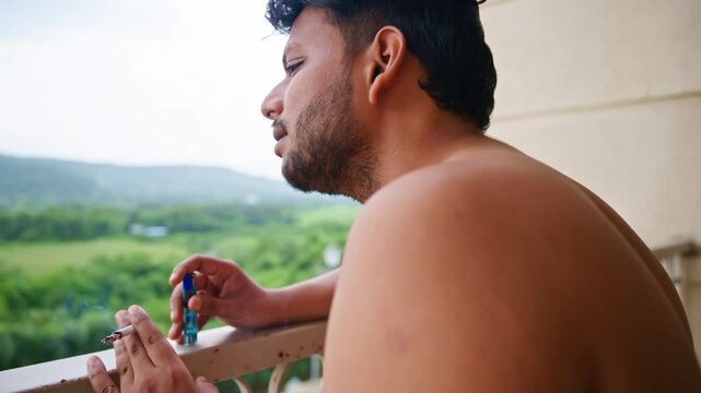 Tensed Man Smoking on Balcony